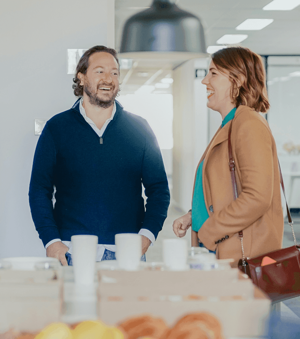 A man and a woman talk to each other at an event